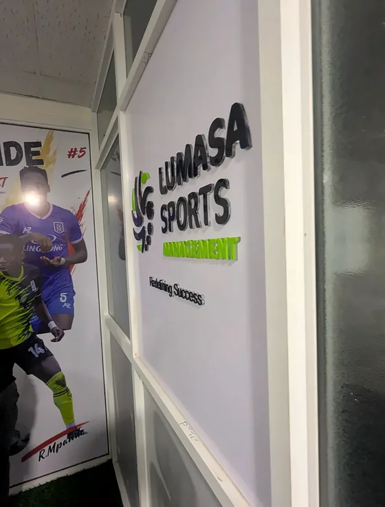 Lumasa Sports wall graphic with an athlete image on a glass partition.