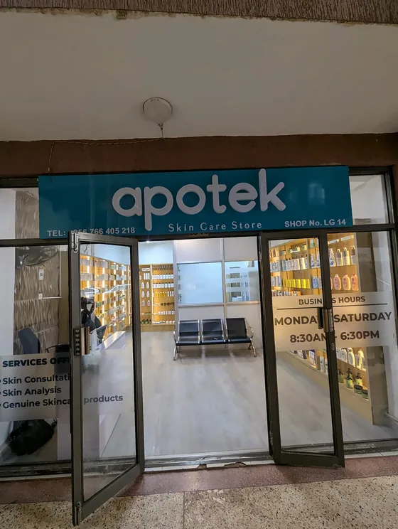 Teal apotek fascia above the glass doors of a skin care store.